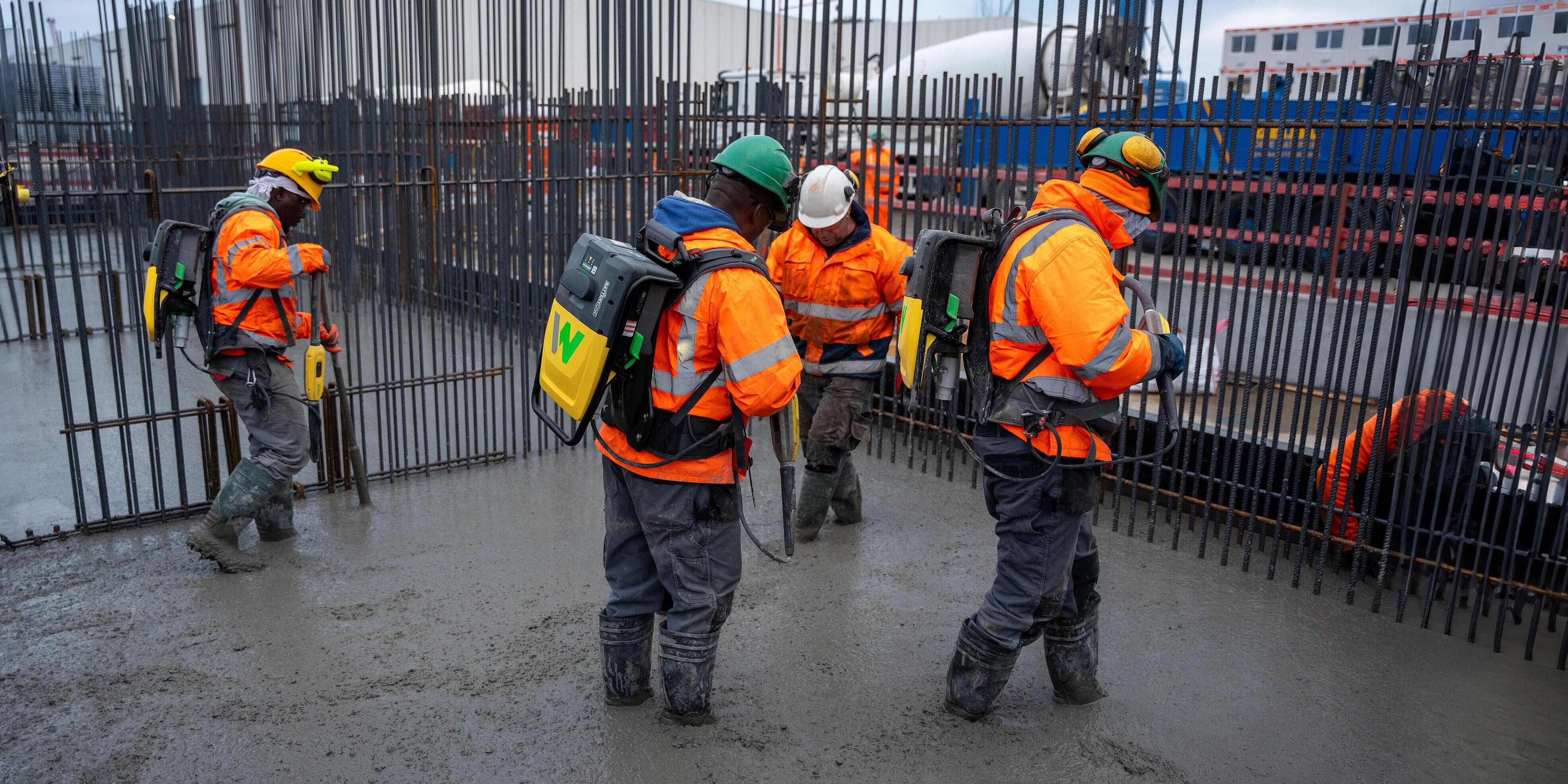 some workers consolidating concrete