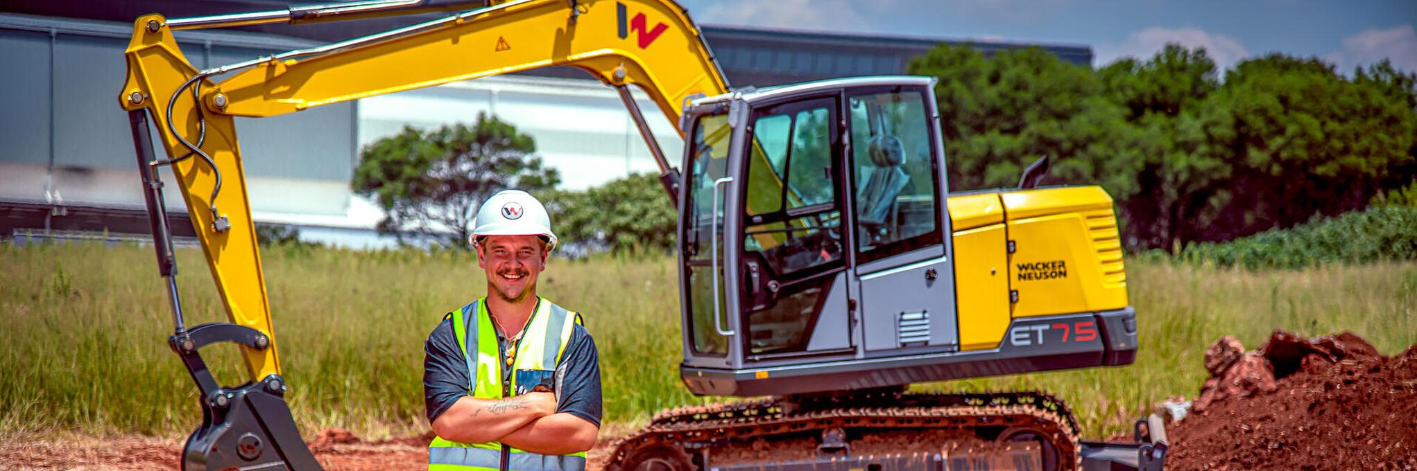 wacker neuson ET75 excavator an colleague smiling